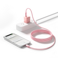Pink braided TORRAS NeoCable charging a phone from a wall outlet