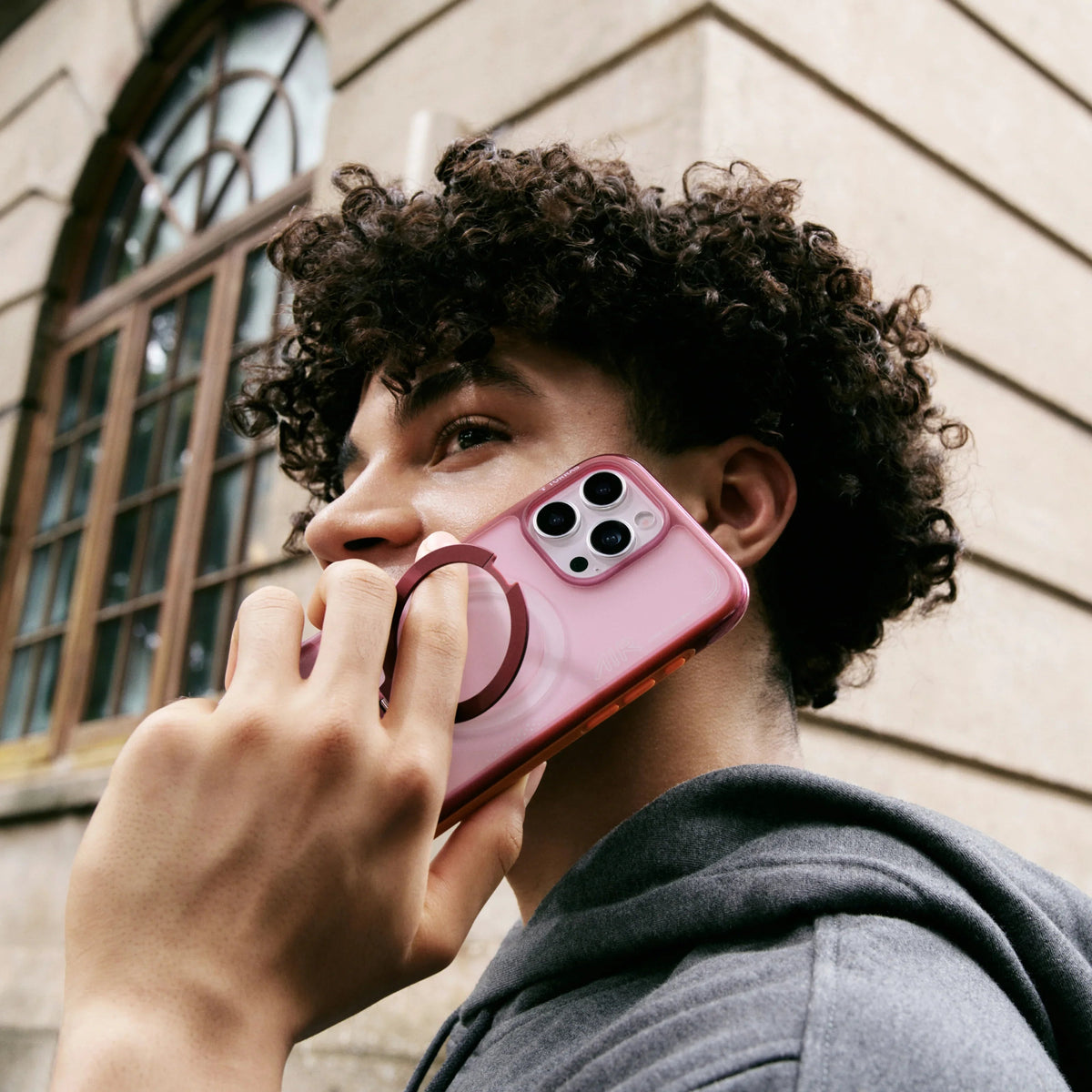 Pink TORRAS Ostand Q3 Air magnetic stand case for iPhone 15 Pro with ring grip.