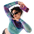 TORRAS Ostand O3 Hue case for iPhone 18 Pro/Pro Max in plum with an orange ring stand, lifestyle scene of a woman in tie-dye mesh
