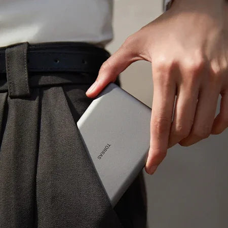 Sleek grey TORRAS MiniMag power bank, 10k mAh, fits easily in pocket.
