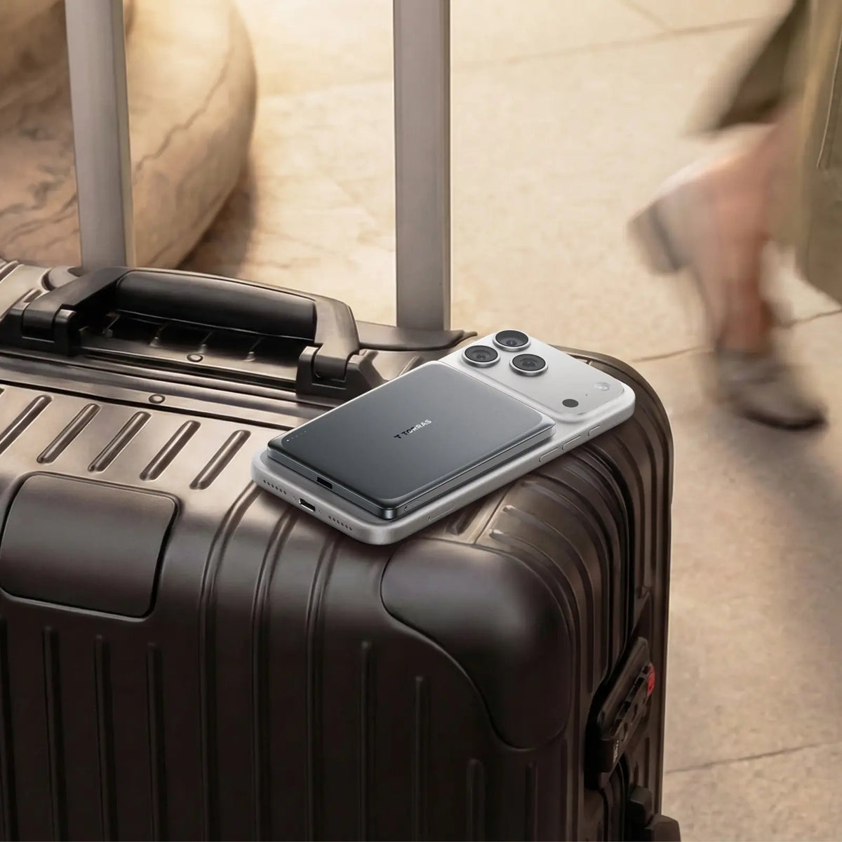 TORRAS MiniMag Pro 5k mAh magnetic power bank attached to iPhone on suitcase