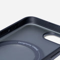 Interior of dark TORRAS Ostand O3 magnetic iPhone case, showing MagSafe ring and "Designed by TORRAS".