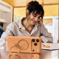 Orange TORRAS Ostand Q3 silicone case with gold magnetic ring stand for iPhone 17 Pro.