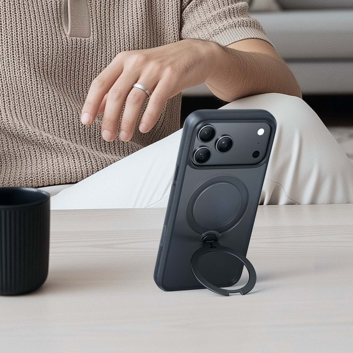 TORRAS Ostand Q3 Spin case for iPhone 17 in dark grey with magnetic ring stand extended.