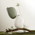 TORRAS FlexLine Pebble Power Bank 10k mAh in green and white, with cords, on mossy log.