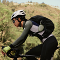 TORRAS Pebble Power Bank clipped via hook to cyclist's backpack.