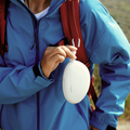 TORRAS Pebble Power Bank 10k mAh with hook, clipped to backpack for outdoor portability.
