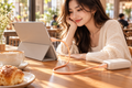 TORRAS Ice Gold orange USB-C cable charging a tablet in a cafe