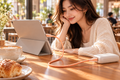 TORRAS Ice Gold orange USB-C cable charging a tablet in a cafe