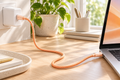 TORRAS Ice Gold orange USB-C cable connecting a charger and laptop