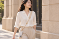 Apricot crossbody phone lanyard worn for everyday carrying; phone and case not included