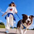 PearlGo clipped to clothing with USB-C lanyard cable ends while walking a dog